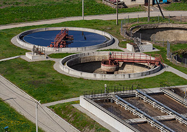 What does "PE" mean in a wastewater treatment plant?