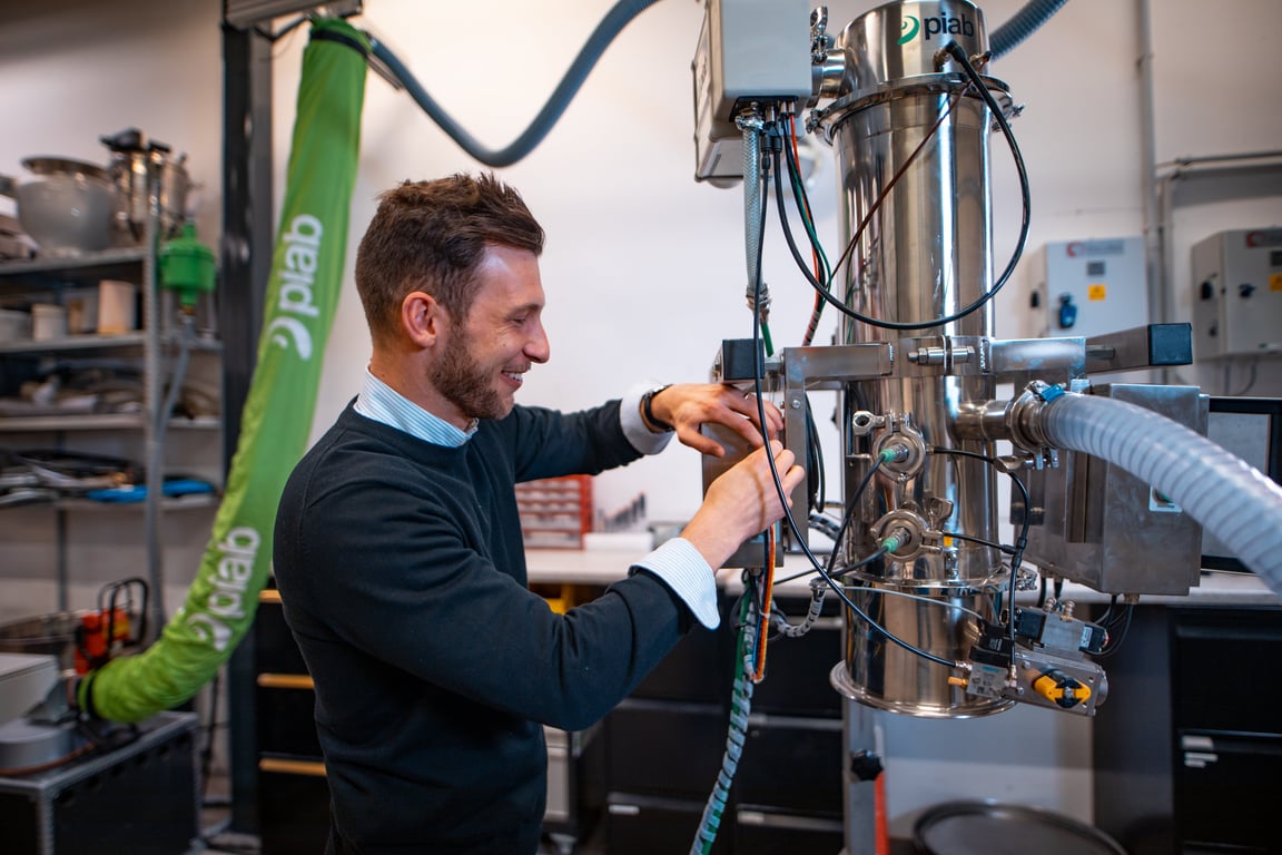 Application engineer adjusting a vacuum conveyor